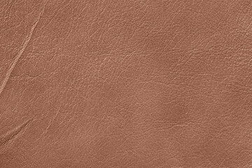 Brown leather surface with visible creases and natural grain. Concept of vintage material