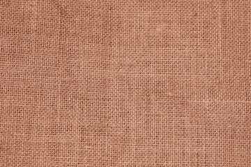 Burlap fabric texture with detailed woven fibers in natural brown tones. Rustic material and eco-friendly textile
