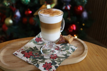 New Year's cappuccino on the background of a Christmas tree with toys