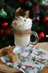New Year's cappuccino on the background of a Christmas tree with toys.