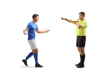 Football player walking towards a referee with a whistle