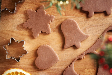 Shapes cut out from raw pastry dough - preparation of homemade gingerbread Christmas cookies, top view