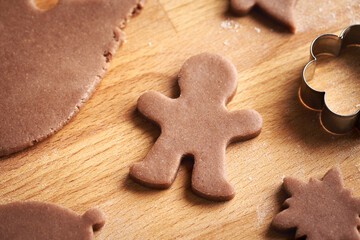 Man shape cut out from raw pastry dough - preparation of homemade gingerbread Christmas cookies