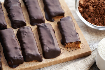 Healthy vegetarian protein chocolate bars with a scoop of whey protein powder