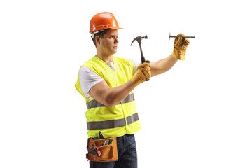 Worker holding a nail and a hammer