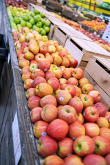 ripe red apples on the produce aisle at the farm store.