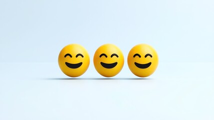 Obraz premium Three cheerful emoji balls with smiling faces on a light background.
