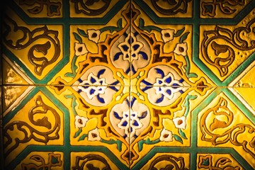 Colorful vintage surface with an old oriental pattern. The background is a texture that has a decorative value. For overlay or texture designs