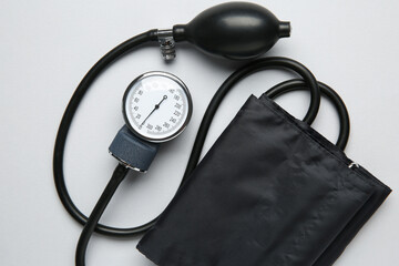 Blood pressure measuring device on light grey background, top view