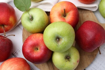 Different whole ripe apples on white wooden table, flat lay