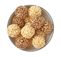 Tasty puffed rice balls in bowl isolated on white, top view