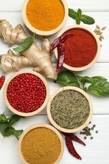 Different aromatic spices on white wooden table, flat lay