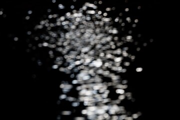 Obraz premium Blurred bokeh with sparkling water glitter with cool mist flash effect