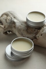 Natural solid perfume and snag on white table, closeup