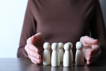 Human resources concept. Woman with wooden pieces at table, closeup