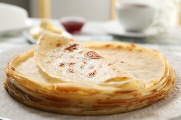 Stack of delicious crepes on table, closeup