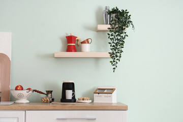 Coffee machine with cup and food on counter in kitchen