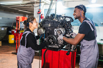 Mechanics repairing car engine in auto repair shop