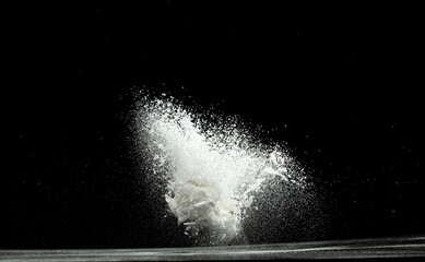 Baking soda powder explode in mid air. Powder of baking soda flying like explosion splashing,...