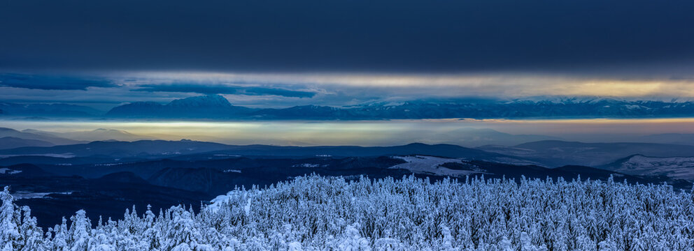 View from the Hargita mountains towards the Eastern Carpathians at sunset, Romania. You can see the Piatra Craiului mountains, the Fagarasi mountains, and a part of Bucegi.