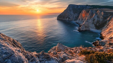 Sunset over coastal cliffs. Dramatic seascape, travel destination.