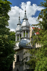 The facade of the historic baroque church with tin belfries in Stary Dworek