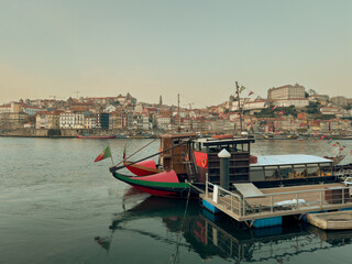 Obraz premium Traditional Rabelo boats, once used to transport port wine along the Douro River, now symbolize Portugal s rich winemaking heritage.