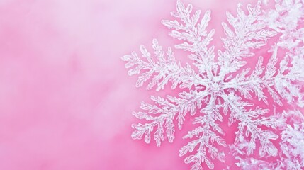 Close-up intricate snowflake on pink.