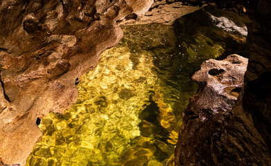 Underground cave te anau new zealand water clear drops rocks stones