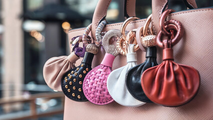 Colorful bag charms attached to a purse