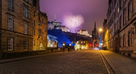 Obraz premium Fireworks over historic castle viewed from cobblestone street at night