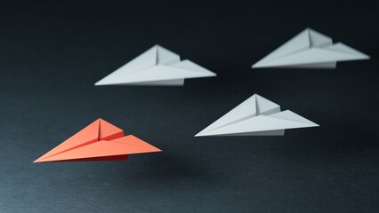 Different business concept.new ideas. paper art style. creative idea.Leaderplane concept, red leader plane leading white planes.3D rendering on black background.