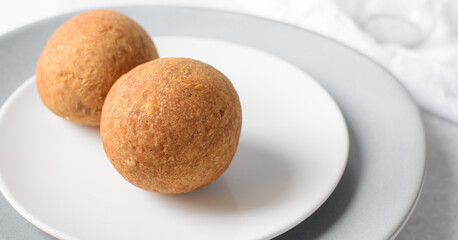 homemade nigerian egg roll in a white ceramic plate, freshly made african egg roll on a white plate, egg wrapped in fried dough