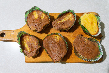 Delicious homemade chocolate cupcakes arranged on a wooden board