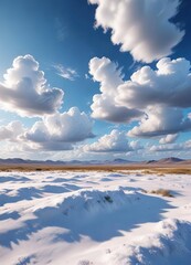 Serene blue sky with fluffy white clouds floating above it in a vast open landscape, sunny day scene, vastness