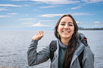 Puerto Varas, Los Lagos, Chile. Young woman traveler - tourist next to the snow-capped volcano...