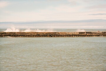Waves Hitting the Breakwater Concrete Wall on a Sunny Day, Ocean Splashing against Seawall