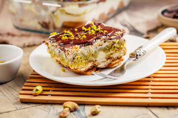 Homemade tiramisu with pistachio mousse and dark chocolate