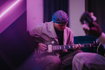 Multiracial musicians are deeply immersed in creating music during a vibrant jam session. The image captures the passion and creativity of the artists as they collaborate in an inspiring environment.
