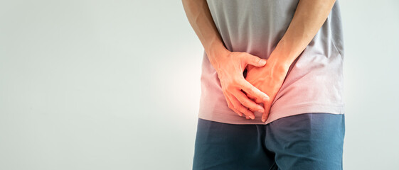 Man hold hand in front of private parts feeling discomfort from disease and inflammation. Venereal,...
