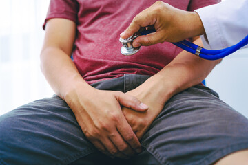 A man suffering from urinary tract infections visits a doctor at the examination table in a hospital.symptoms, discusses benign prostatic hyperplasia (BPH), and provides advice and treatment