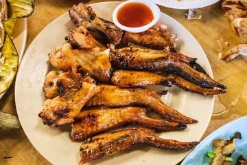 Delicious Grilled Chicken Wings with Dipping Sauce on a Plate