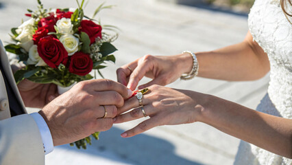 couple exchanging wedding rings during romantic ceremony, surrounded by beautiful flowers