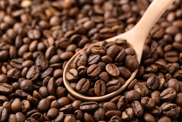 Roasted coffee beans with wooden spoon, Arabica coffee