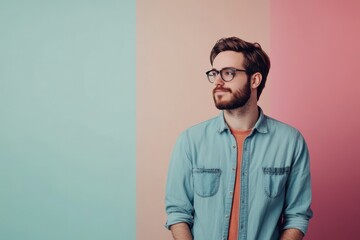 Fototapeta premium Stylish Young Man Posing Against a Colorful Background in Casual Attire