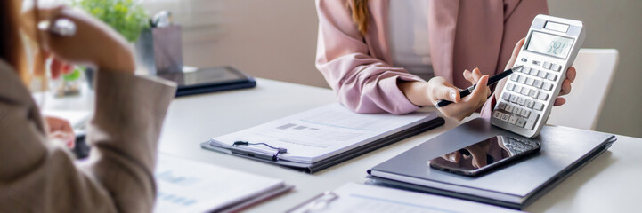 Business woman analyzing data paperwork calculating numbers