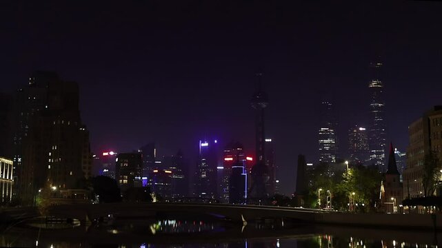 Shanghai Skyline at Night. Urban District, Huangpu River and skyscrapers. China. Illuminated cityscape. Waitan embankment.