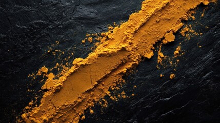 Golden Turmeric Powder Spilled On Black Stone