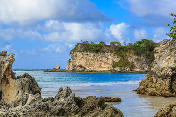 A rocky shoreline with a blue ocean in the background