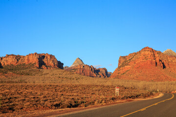 A road in the desert with a sign on the side © Scott Prokop